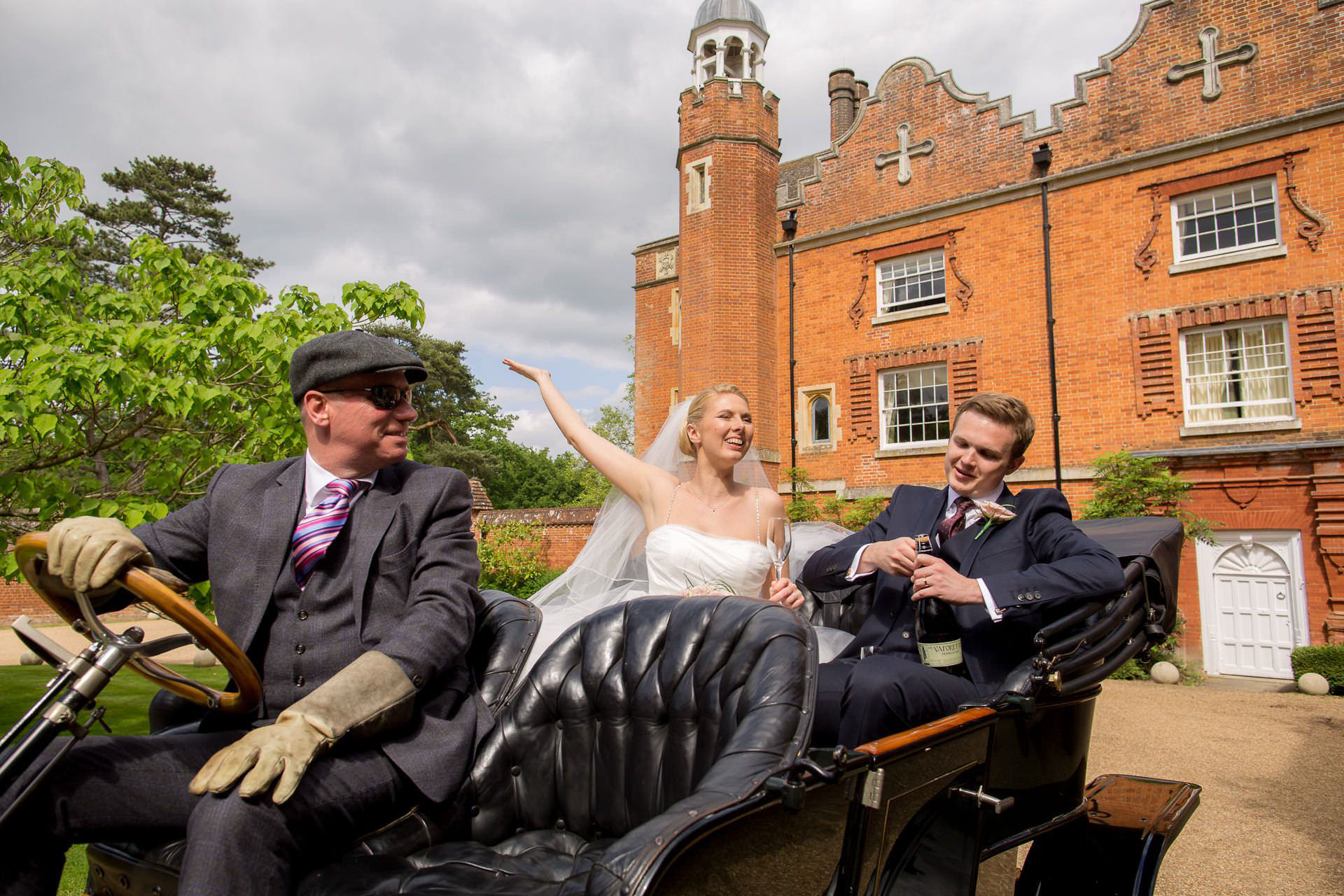 Wotton House wedding bride and groom open the champagne