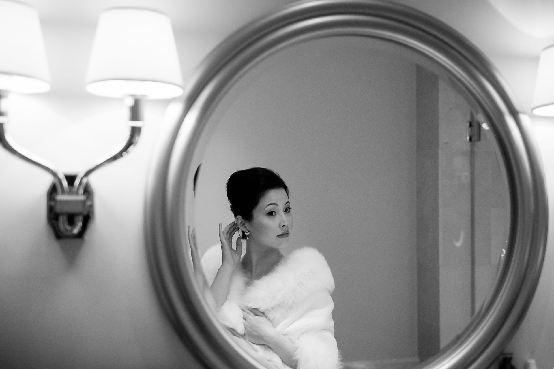 Chinese wedding bride looking in the mirror