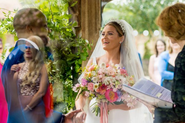 Bride just arrived to the ceremony and looks at the groom