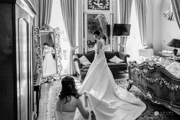 Cambridge Wedding Photographer bride is getting ready with the dress