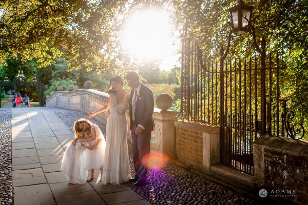bride, groom and flower girls on the bridge