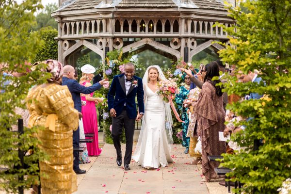 Cambridgeshire Wedding Photographer taking photo of the couple walking the aisle after their ceremony