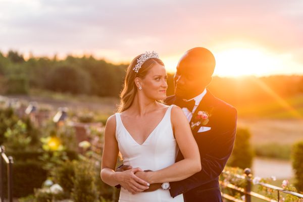 Cambridgeshire Wedding Photographer taking photo of the newlyweds at the magic hour