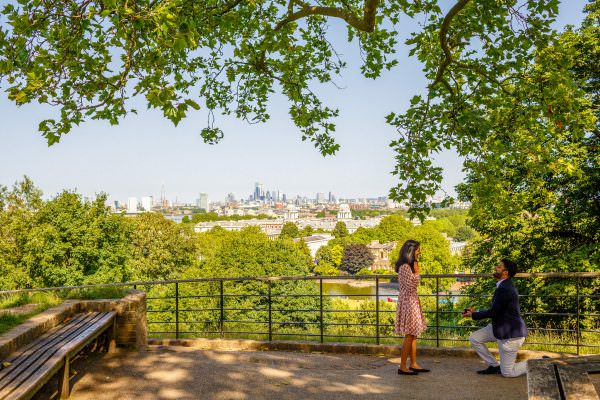 An emotional proposal moment captured at the Royal Observatory viewpoint in Greenwich Park.