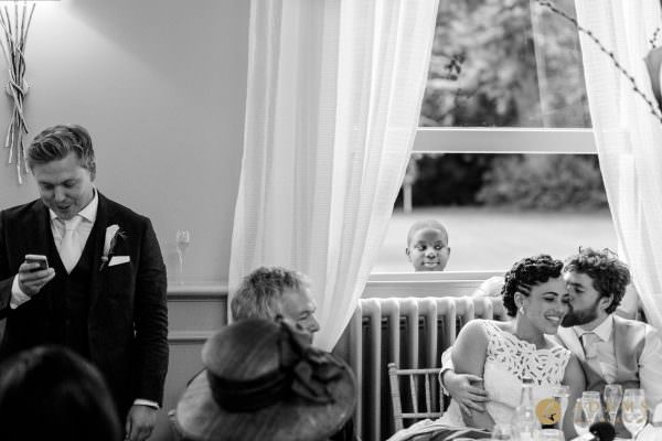 Couple kissing during the wedding speeches