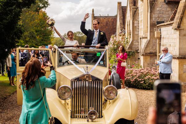 Bride and groom in there car leaving the church