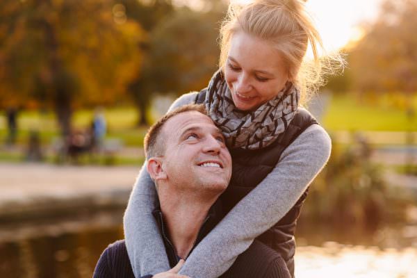 A joyful, newly engaged couple sharing a close embrace during an intimate engagement shoot in London.