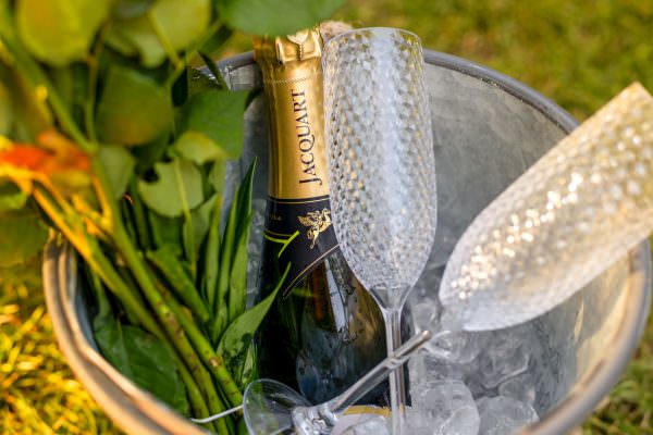 A chilled bottle of champagne nestled in a silver ice bucket with crystal flutes, perfectly prepared for a luxury marriage proposal in London.