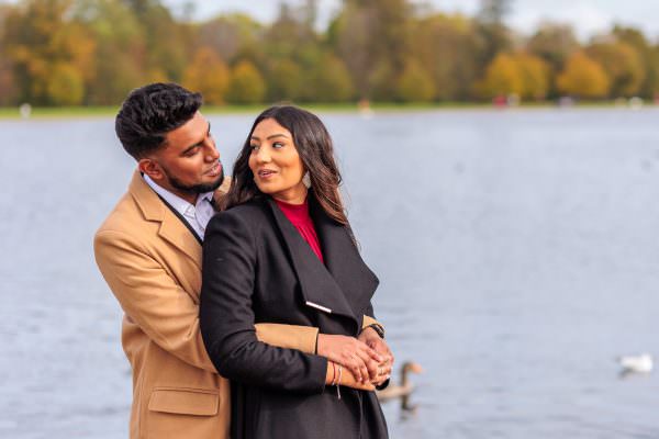 A close-up portrait of a bride-to-be smiling over her shoulder at her partner during their London post proposal shoot.